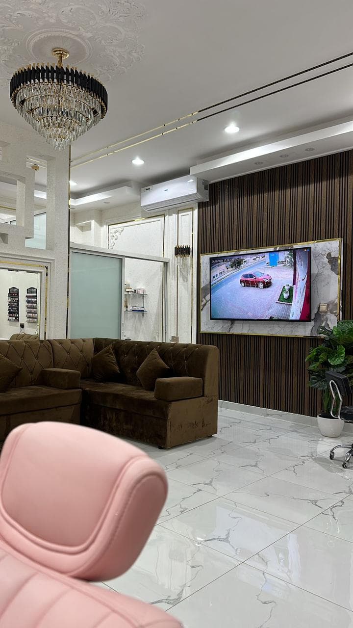 Waiting lounge with chandelier and wall-mounted TV