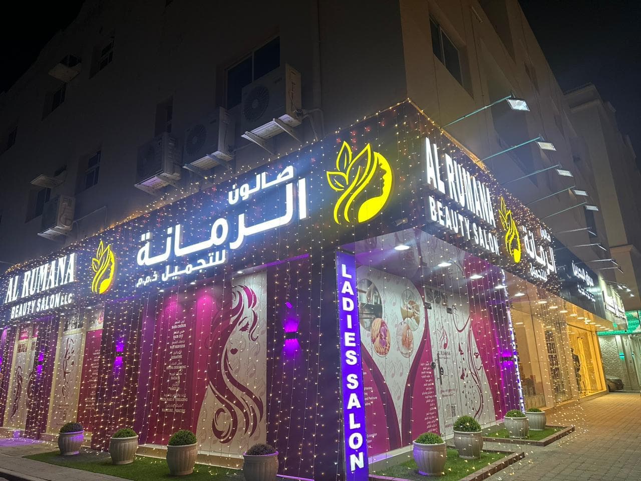 Rumana Saloon storefront lit up at night, Masafi