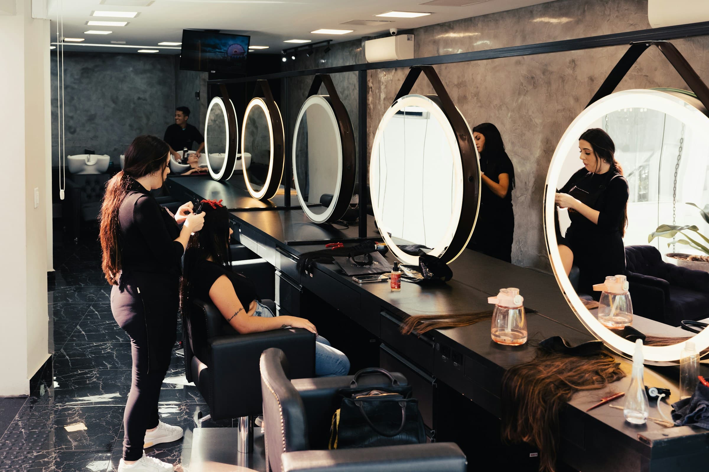 Stylists at work in the salon's mirror styling stations